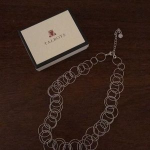 1 Silver tone necklace.